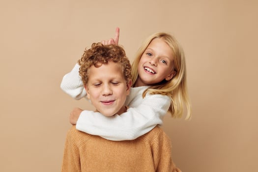 Portrait of cute children in sweaters together fun isolated background photo