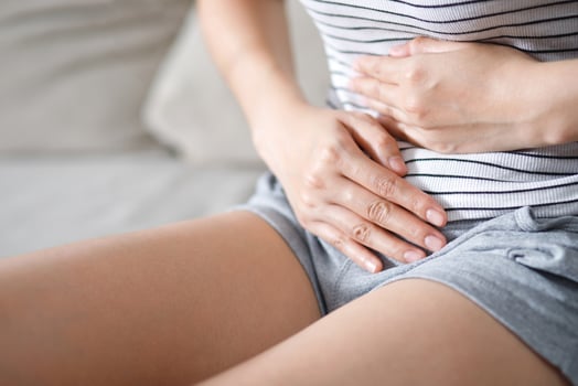 Woman having a stomachache, or menstruation pain. suffering from abdominal. Menstrual cramps. Healthcare and medical, gynecology concept. photo