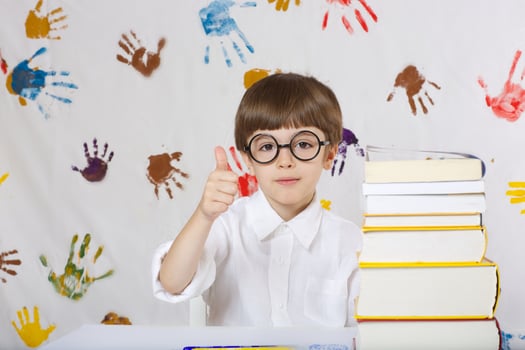 Boy of seven years old with books. Back to school photo