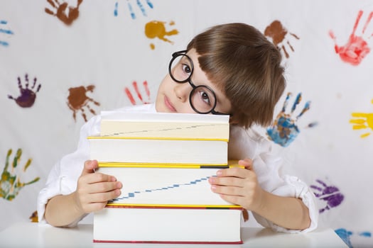 Boy of seven years old with books. Back to school photo
