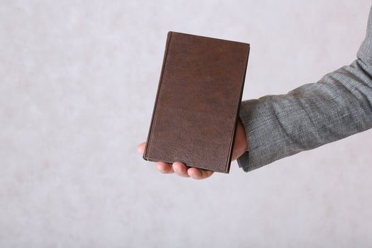 A book in a man's hands. Closeup photo
