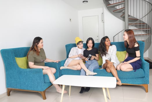 Young Asian woman group talk gossip chat sing party fun enjoy emotion on blue living room sofa photo