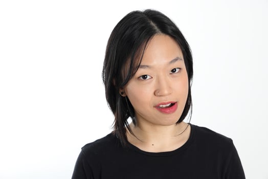 Young attractive south east asian woman pose face expression emotion on white background smile witty photo