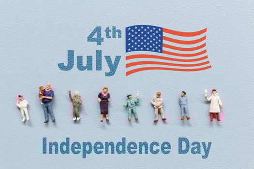 Group of people celebrating the Fourth of July with the American flag in the background. photo
