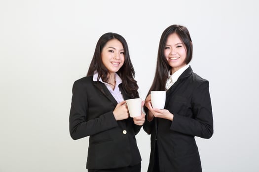 Two young asian malaysian business office woman holding blank copy text space sign board on white background photo