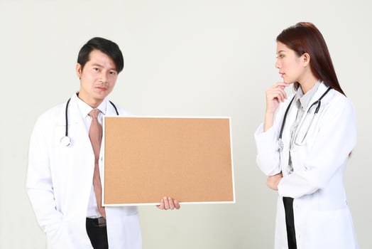 Young Asian male female doctor wearing apron uniform tunic apron hold photo