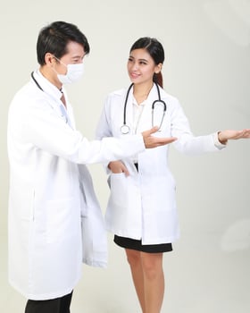 Young Asian male female doctor wearing apron uniform tunic apron hold photo