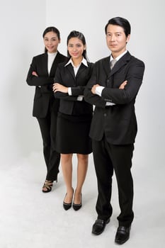 Young Asian male female wearing business office suit stand look at camera cross hand photo