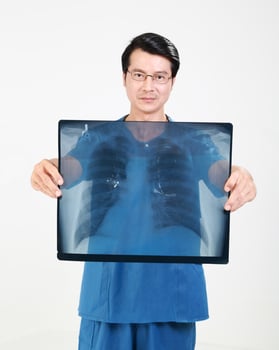 Young Asian male doctor wearing apron uniform tunic hold photo