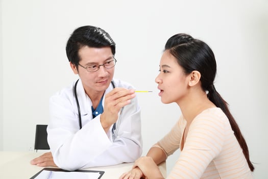 Young Asian male doctor wearing apron uniform stethoscope female patient talk discuss cheek photo