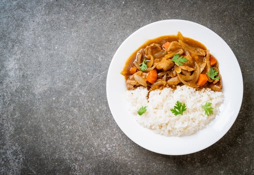Japanese curry rice with sliced pork, carrot and onions photo