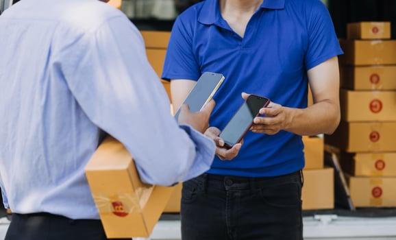 Blue Delivery Men Unloading Package From Truck With Face Mask photo