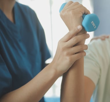 Physiotherapist man giving exercise with dumbbell treatment About Arm and Shoulder of athlete male patient Physical therapy concept photo