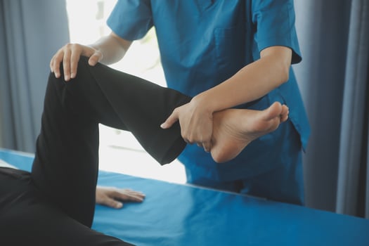 Physiotherapist working with patient in clinic, closeup photo