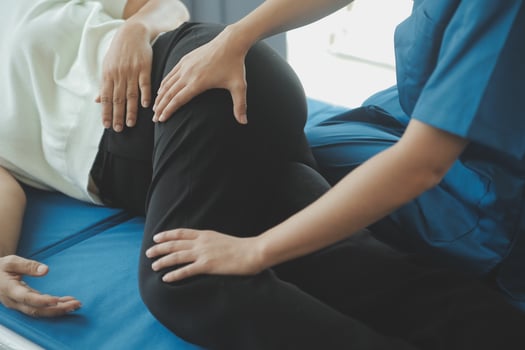 Physiotherapist working with patient in clinic, closeup photo