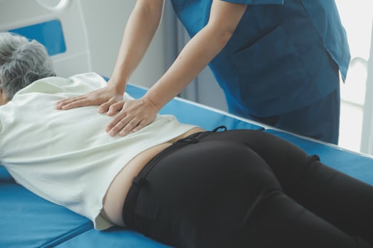 Physiotherapist working with patient in clinic, closeup photo