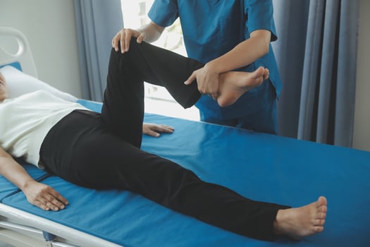 Physiotherapist working with patient in clinic, closeup photo