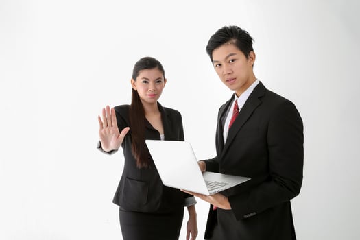 Asian young Chinese man woman wearing formal business office ware on white background holding laptop stop hand sign photo