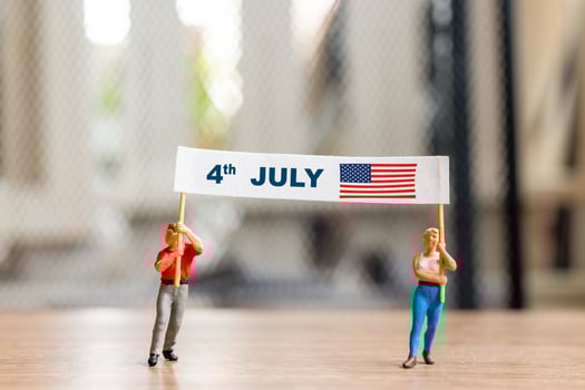 Americans raising flags in celebration of the Fourth of July and Independence Day photo