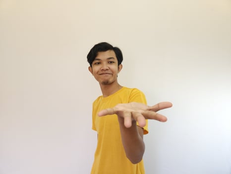 man with hand gesture promote product for advertising at copy space photo