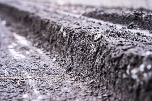 A close view of a cross-section of the old road surfac. repair photo
