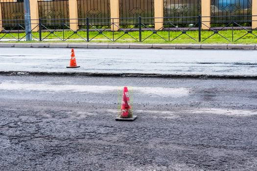 white-orange traffic cones on the city highway during road repairs photo