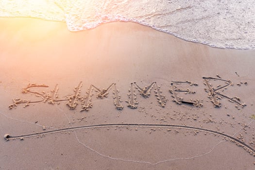 word Summer on the sand on the sea sandy beach in the sunset light photo