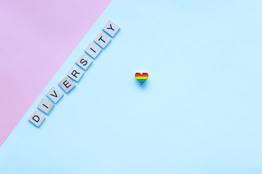 Flat lay pride heart icon. LGBT. Pride month and day. Word diversity from wooden letters photo