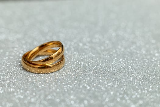 Will you marry me. Two golden wedding rings on silver glitter background. Engagement marriage proposal wedding concept. St. Valentine's Day postcard. Banner on valentines day. Copy space. photo