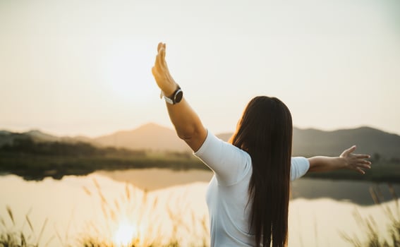 Happy woman spreading arms and watching the mountain. Travel Lifestyle success concept adventure active vacations outdoor freedom emotions. photo
