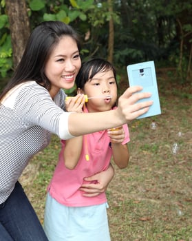 South East Asian young father mother daughter son parent boy girl child activity outdoors park photo