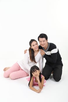 South East Asian father mother daughter parent child happy look at camera on floor white background photo