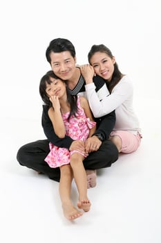 South East Asian father mother daughter parent child happy sit on lap love look at camera on floor white background photo