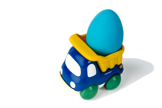 A toy children's dump truck transports an Easter gift egg photo