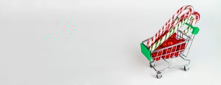 A supermarket trolley loaded with candies and Christmas caramel canes photo