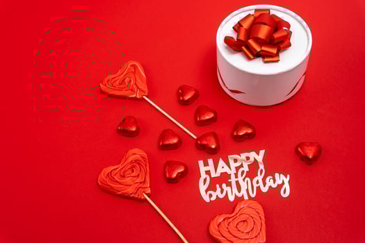 gift box with a ribbon and a bow, heart-shaped chocolates photo