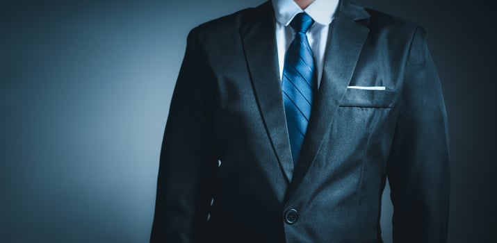businessman standing on dark gradient background. business concept. suit. photo
