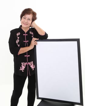 Elderly asian Chinese female wearing black tang samfu on white background photo