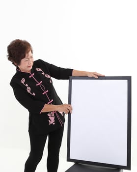 Elderly asian Chinese female wearing black tang samfu on white background photo
