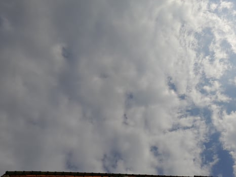 White clouds in the blue sky. Beautiful bright blue background. Light cloudy, good weather. Curly clouds on a sunny day. photo