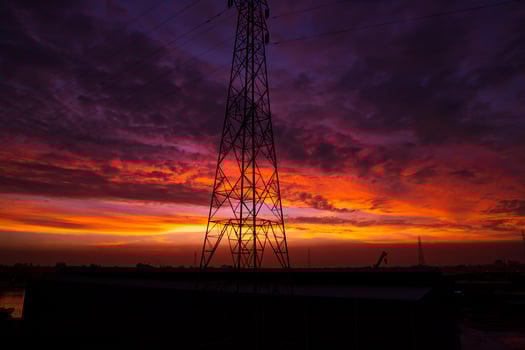 High voltage power line tower with beautiful sky at sunset, stock photo