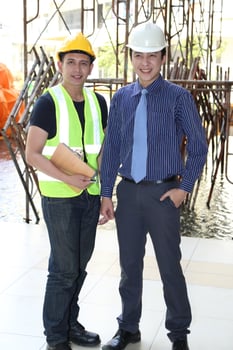 South East Asian young Malay Chinese man woman wearing safely helmet construction site work photo