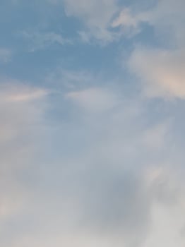 White clouds in the blue sky. Beautiful bright blue background. Light cloudy, good weather. Curly clouds on a sunny day. photo