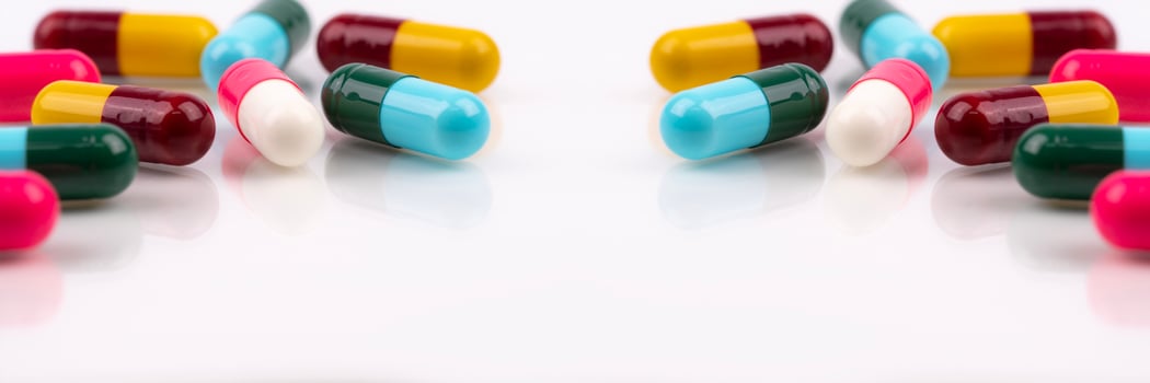 Antibiotic capsule pills on white background. Antibiotic drugs. Healthcare and medicine. Pharmaceutical industry. Prescription drugs. Pharmacology for pharmacists and doctors. Online pharmacy banner. photo