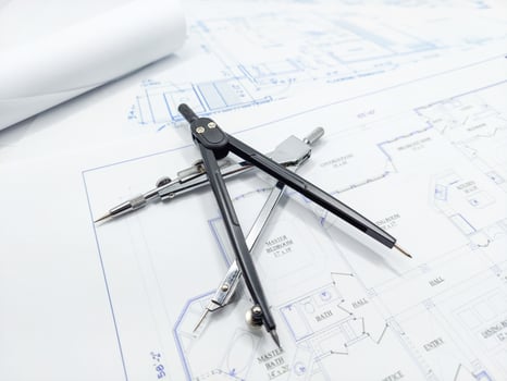 Paper home floor plan with compass. Architectural sketching process concept. Floor plan on architect's desk. photo