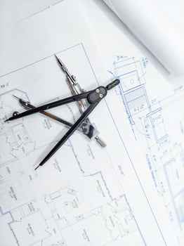 Paper home floor plan with compass. Architectural sketching process concept. Floor plan on architect's desk. photo