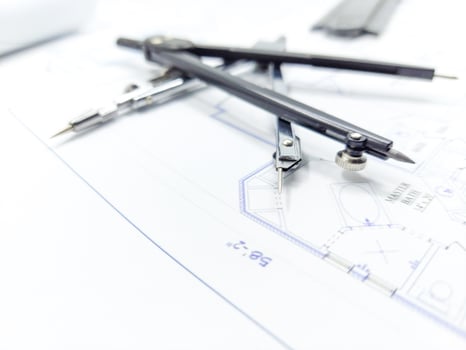 Paper home floor plan with compass. Architectural sketching process concept. Floor plan on architect's desk. photo