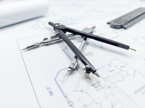 Paper home floor plan with compass. Architectural sketching process concept. Floor plan on architect's desk. photo