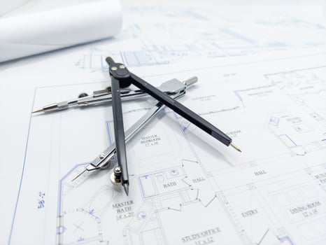 Paper home floor plan with compass. Architectural sketching process concept. Floor plan on architect's desk. photo