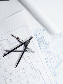 Paper home floor plan with compass. Architectural sketching process concept. Floor plan on architect's desk. photo